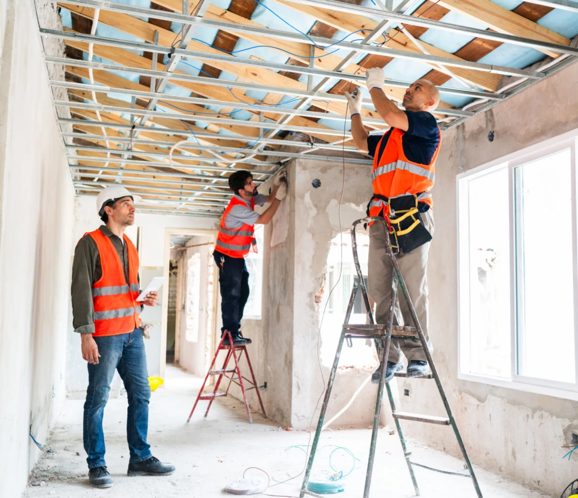 Team fixing ceiling in building renovation